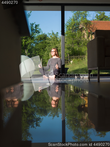 Image of young woman doing morning yoga exercises