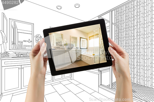 Image of Hands Holding Computer Tablet with Master Bathroom Photo on Scre