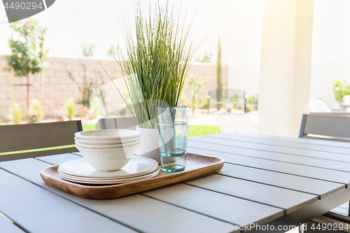 Image of Outdoor Patio Setting with Dishes and Glasses on Tray