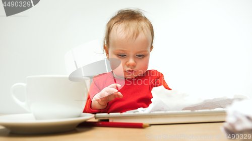 Image of Happy child baby girl toddler sitting with keyboard of computer isolated on a white background