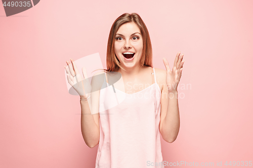 Image of Beautiful woman looking suprised isolated on pink