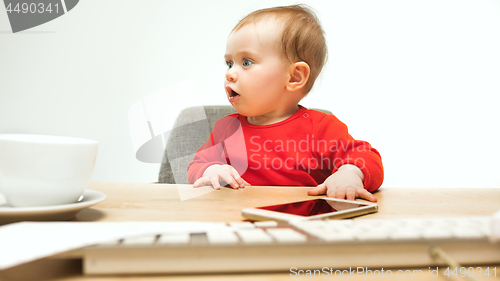 Image of Happy child baby girl toddler sitting with keyboard of computer isolated on a white background