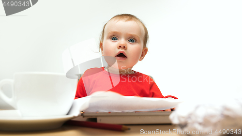 Image of Happy child baby girl toddler sitting with keyboard of computer isolated on a white background