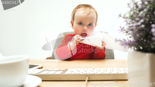 Image of Happy child baby girl toddler sitting with keyboard of computer isolated on a white background