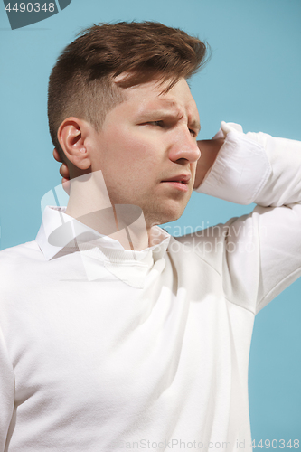 Image of Beautiful bored man isolated on studio background