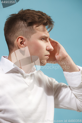 Image of Young serious thoughtful businessman. Doubt concept.