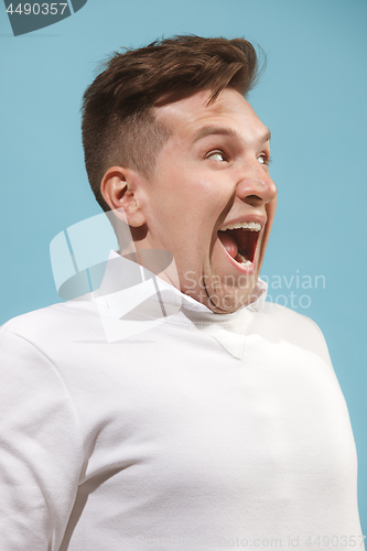 Image of The happy business man standing and smiling against studio background.