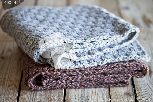 Image of knitted woolen grey and brown scarves