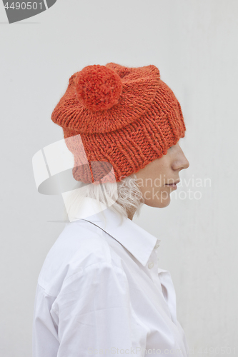 Image of Pretty young woman in warm orange beanie