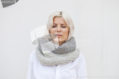 Image of Pretty young woman in warm grey wool knitted snood