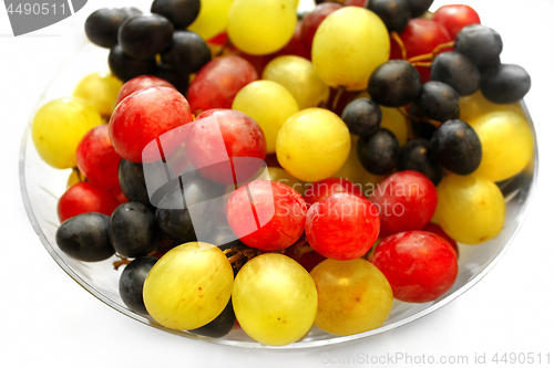 Image of Bright assortment tasty ripe grapes in a glass plate