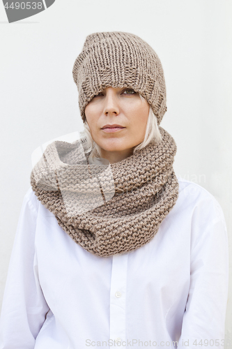 Image of Woman in warm brown knitted hat and snood