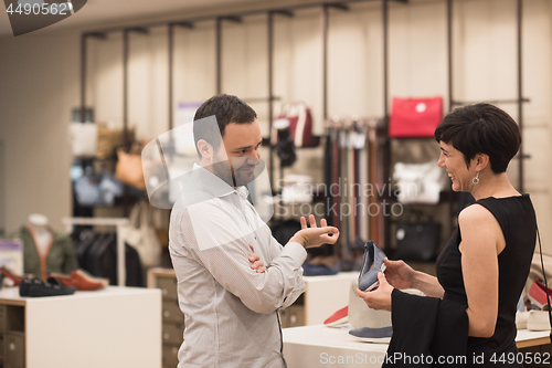 Image of couple chooses shoes At Shoe Store