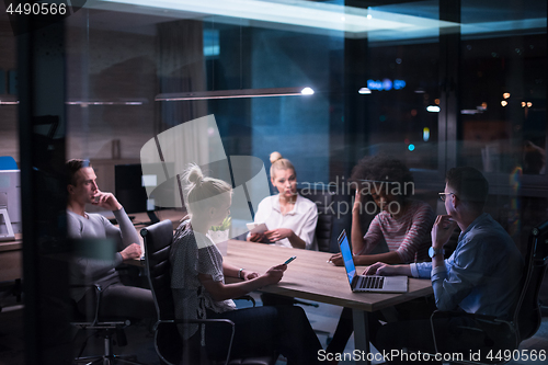 Image of Multiethnic startup business team in night office