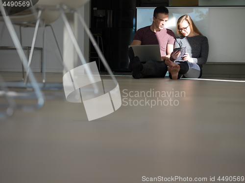 Image of couple using tablet and laptop computers