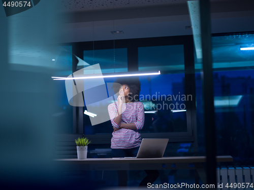 Image of black businesswoman using a laptop in startup office