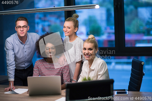 Image of Multiethnic startup business team in night office