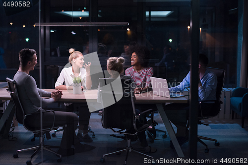 Image of Multiethnic startup business team in night office