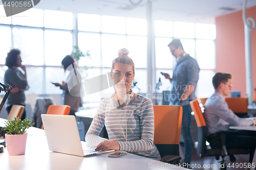 Image of businesswoman using a laptop in startup office