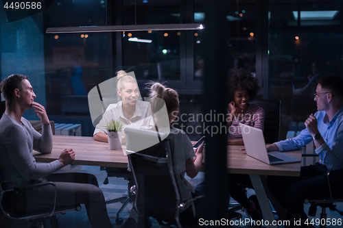 Image of Multiethnic startup business team in night office