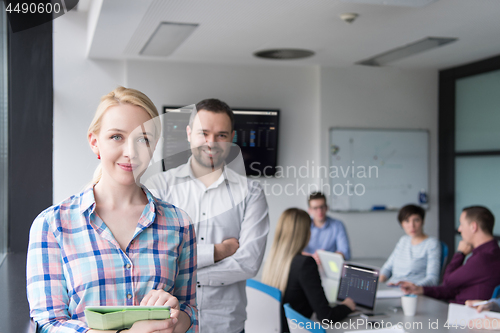 Image of Business People Working With Tablet in startup office
