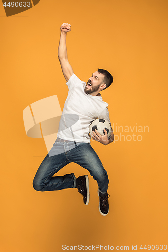 Image of The young man as soccer football player kicking the ball at studio