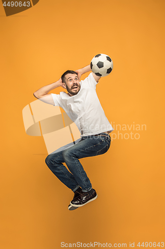 Image of The young man as soccer football player kicking the ball at studio