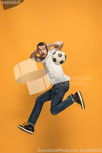 Image of The young man as soccer football player kicking the ball at studio