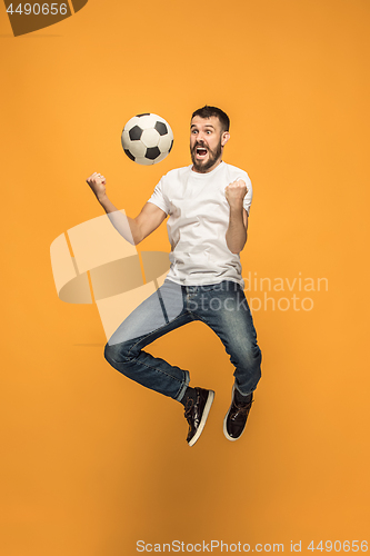 Image of The young man as soccer football player kicking the ball at studio