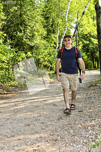 Image of Man walking on forest trail