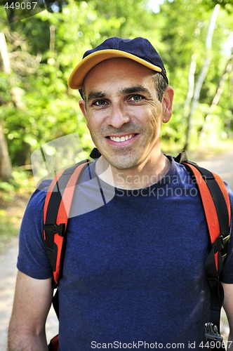 Image of Man hiking on forest trail