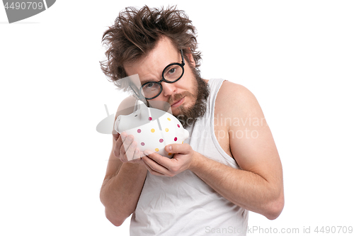 Image of Crazy bearded man with piggy bank