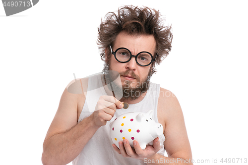 Image of Crazy bearded man with piggy bank