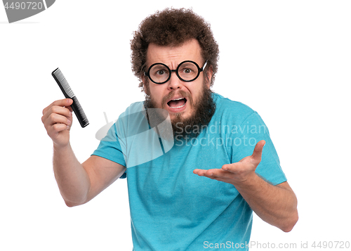 Image of Crazy bearded man with hairbrush