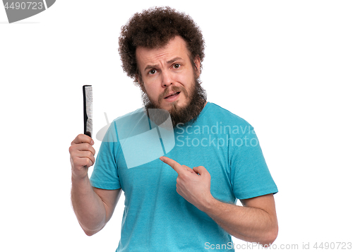 Image of Crazy bearded man with hairbrush