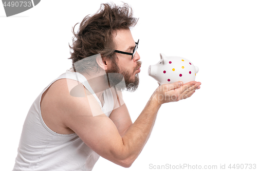 Image of Crazy bearded man with piggy bank