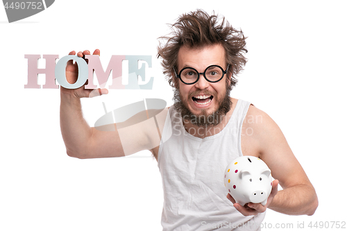 Image of Crazy bearded man with piggy bank