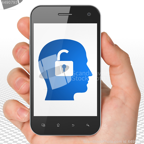 Image of Finance concept: Hand Holding Smartphone with Head With Padlock on display