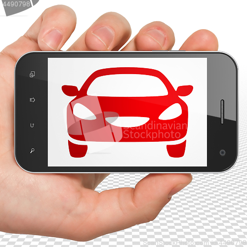 Image of Travel concept: Hand Holding Smartphone with Car on display
