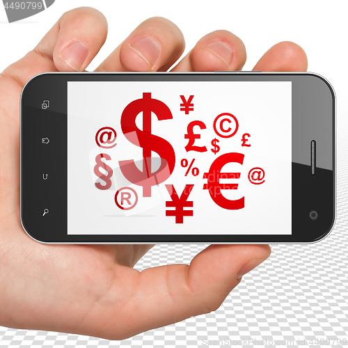 Image of Advertising concept: Hand Holding Smartphone with Finance Symbol on display