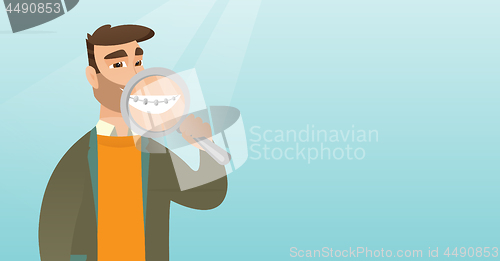 Image of Man examining her teeth with a magnifier.
