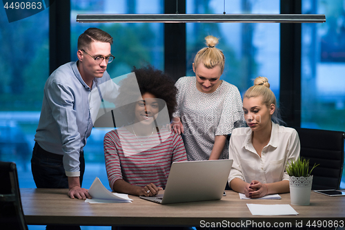 Image of Multiethnic startup business team in night office