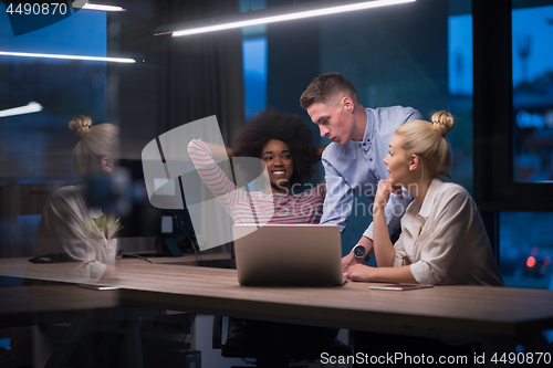 Image of Multiethnic startup business team in night office