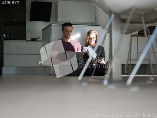 Image of couple using tablet and laptop computers