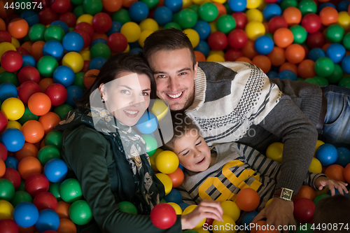 Image of young parents with kids in a children\'s playroom