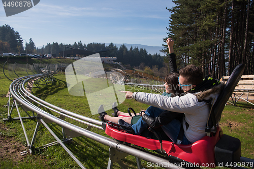 Image of couple enjoys driving on alpine coaster