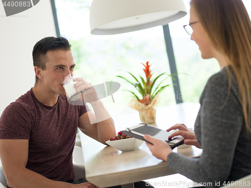 Image of couple enjoying morning coffee and strawberries