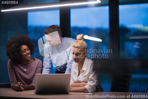 Image of Multiethnic startup business team in night office