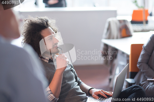 Image of businessman working using a laptop in startup office