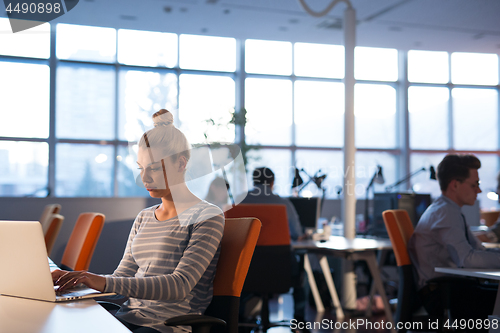 Image of businesswoman using a laptop in startup office